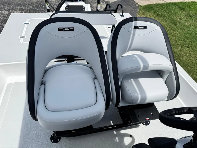 Slide: The Image of 2025 SCB S22 boat seats, white and black, on deck. - 22