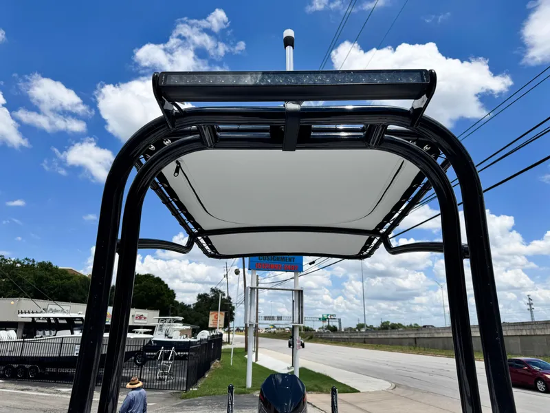 Slide: The Image of 2025 SCB S22 boat with T-top under a clear blue sky. - 23