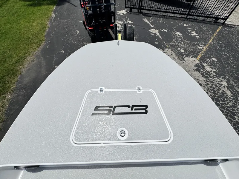 Slide: The Image of 2025 SCB S22 boat deck with logo, parked on a paved surface. - 31
