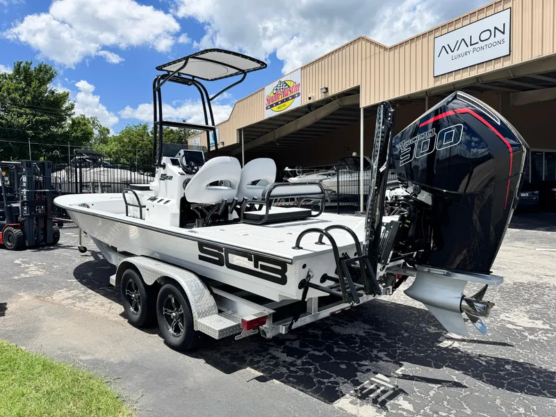 Slide: The Image of 2025 SCB S22 boat on trailer, powerful 300 engine, parked outside Avalon Luxury Pontoons. - 4