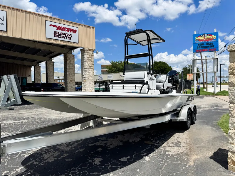 Slide: The Image of 2025 SCB S22 boat on trailer outside dealership under blue sky. - 5