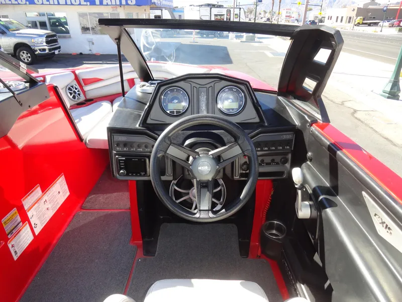 Slide: The Image of 2016 Axis A22 boat interior with steering wheel and dashboard controls. - 11