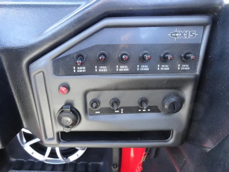 Slide: The Image of Control panel of a 2016 Axis A22 boat with switches and knobs. - 12