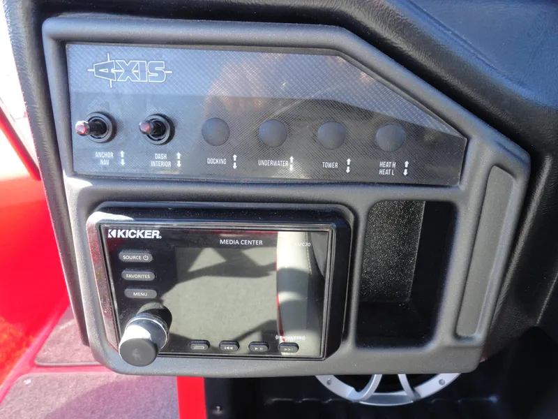 Slide: The Image of 2016 Axis A22 dashboard with Kicker media center and control switches. - 13