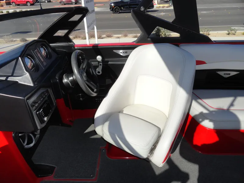 Slide: The Image of 2016 Axis A22 boat interior with white captain's seat and dashboard. - 15