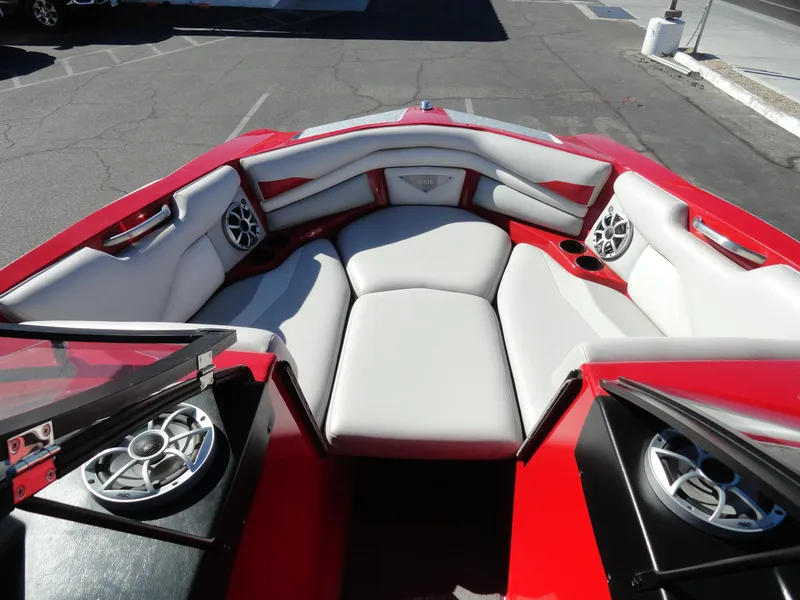 Slide: The Image of 2016 Axis A22 boat interior with red and white seating and speakers. - 20