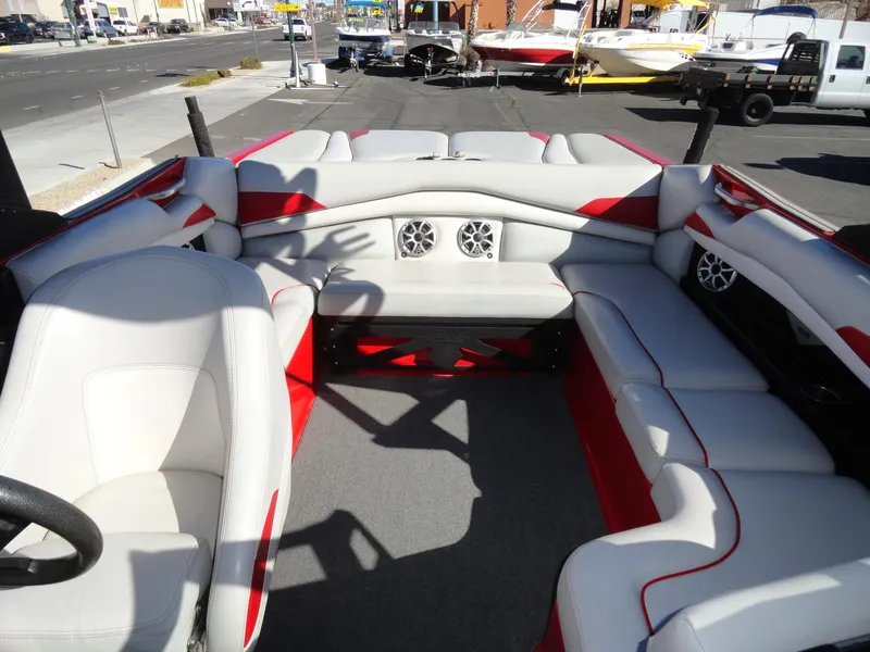Slide: The Image of 2016 Axis A22 boat interior with white and red seating, featuring built-in speakers. - 22