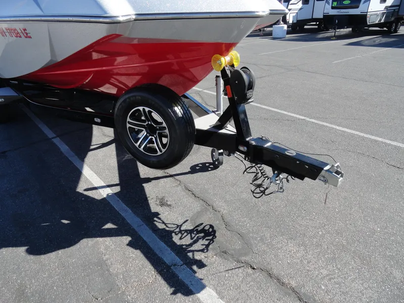 Slide: The Image of 2016 Axis A22 boat trailer with red hull in parking lot. - 25