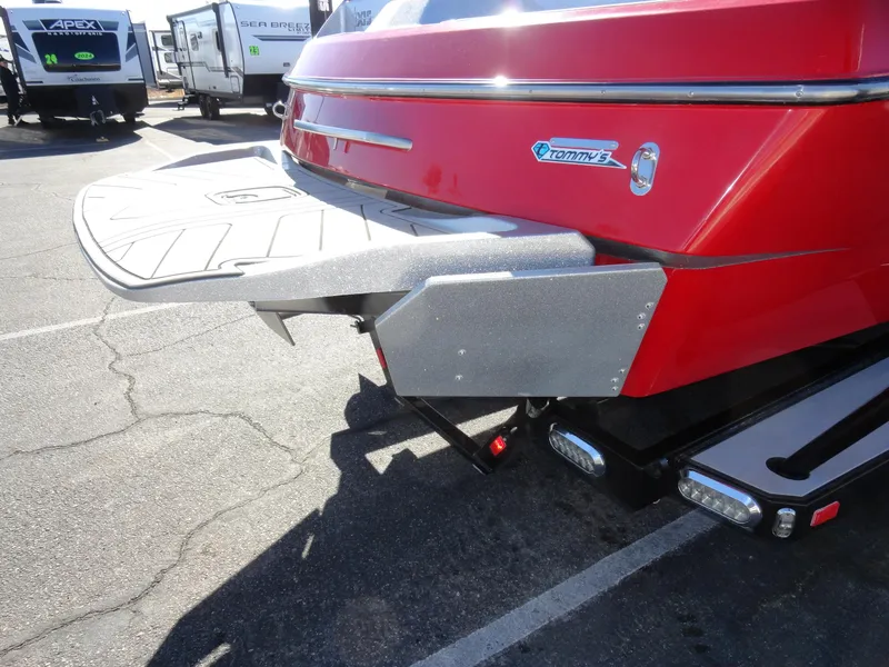 Slide: The Image of 2016 Axis A22 boat rear view with swim platform in a parking lot. - 4