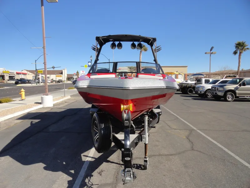 Slide: The Image of 2016 Axis A22 boat on trailer in parking lot, sunny day. - 6