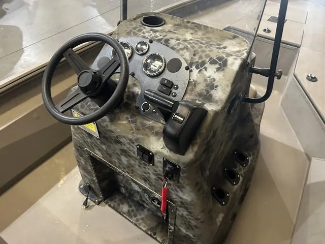 Slide: The Image of 2022 Excel Bay Pro 203 boat console with steering wheel and controls. - 12