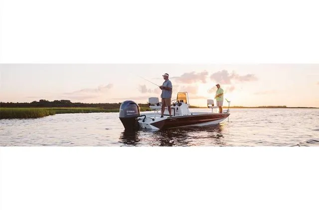 Slide: The Image of 2022 Excel Bay Pro 203 boat on water at sunset with two people fishing. - 16