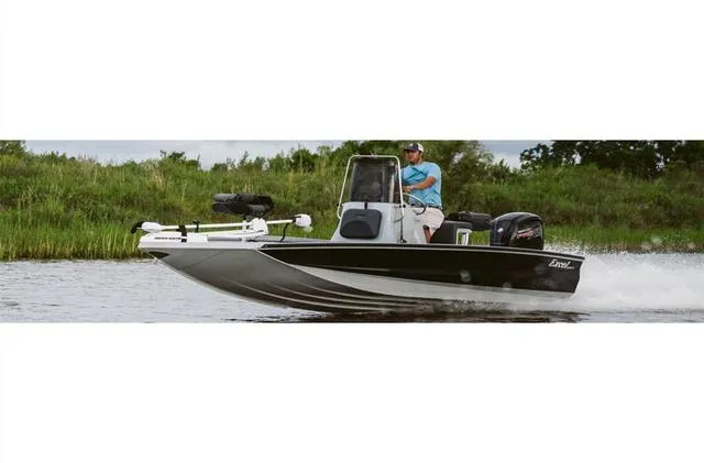 Slide: The Image of 2022 Excel Bay Pro 203 boat speeding on a river with lush greenery in the background. - 18