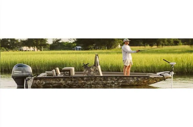 Slide: The Image of 2022 Excel Bay Pro 203 boat with person fishing in scenic marshland. - 21
