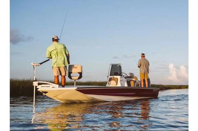 Slide: The Image of 2022 Excel Bay Pro 203 boat with two people fishing on calm water. - 26