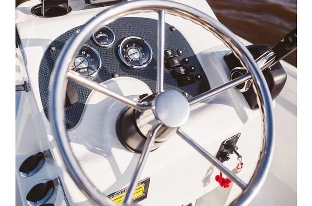Slide: The Image of Steering wheel and dashboard of 2022 Excel Bay Pro 203 boat. - 29