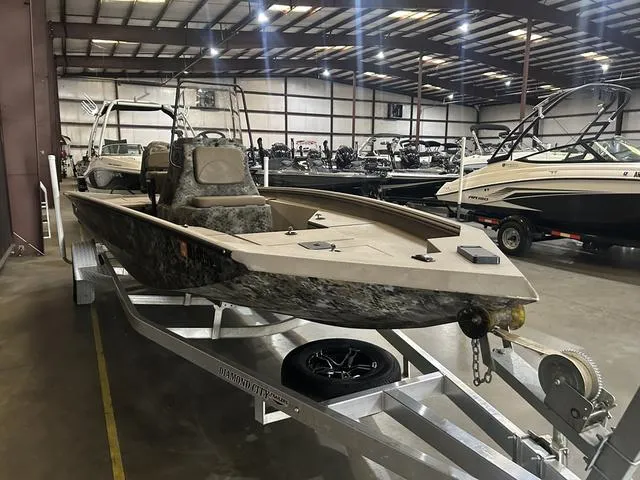 Slide: The Image of 2022 Excel Bay Pro 203 boat on trailer in showroom. - 3