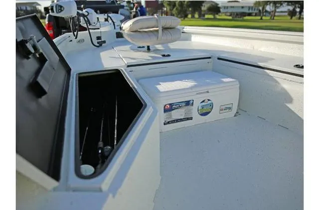 Slide: The Image of 2022 Excel Bay Pro 203 boat interior with storage compartments and fishing gear. - 35