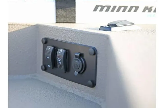 Slide: The Image of Control panel on 2022 Excel Bay Pro 203 boat, featuring switches and a power outlet. - 41