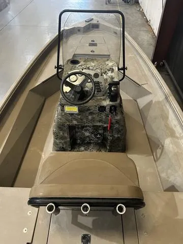 Slide: The Image of 2022 Excel Bay Pro 203 boat interior with steering console and seating. - 6