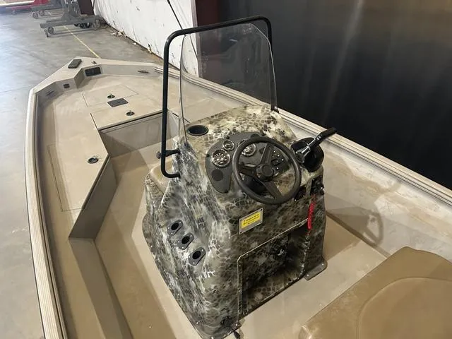 Slide: The Image of 2022 Excel Bay Pro 203 boat interior with camouflage console and steering wheel. - 7