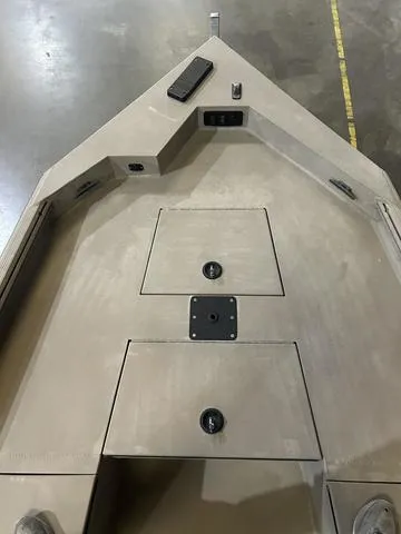 Slide: The Image of 2022 Excel Bay Pro 203 boat interior with storage compartments and non-slip surface. - 8