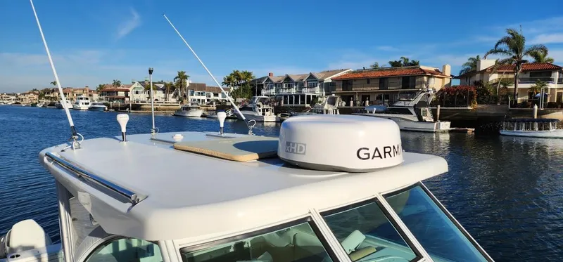 Slide: The Image of 2016 World Cat 2780 Glacier Bay Edition boat with Garmin radar, docked in a scenic marina. - 10