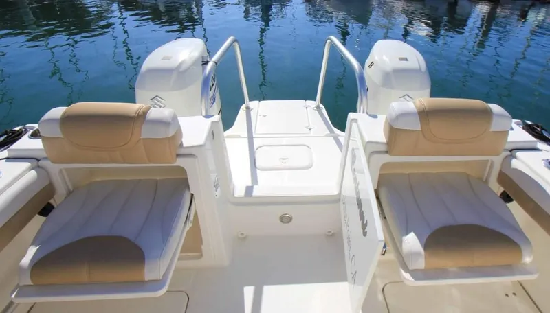 Slide: The Image of 2016 World Cat 2780 Glacier Bay Edition boat interior with dual seating and twin engines. - 11
