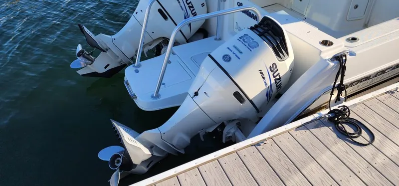 Slide: The Image of 2016 World Cat 2780 Glacier Bay Edition with dual Suzuki outboard motors docked by water. - 14
