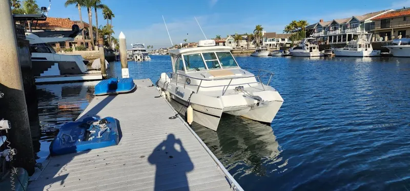 Slide: The Image of 2016 World Cat 2780 Glacier Bay Edition docked in a scenic marina. - 2