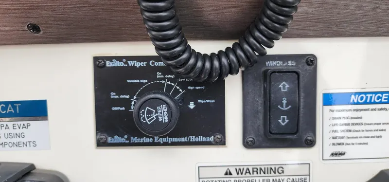 Slide: The Image of Control panel of 2016 World Cat 2780 Glacier Bay Edition boat with wiper and winch controls. - 23