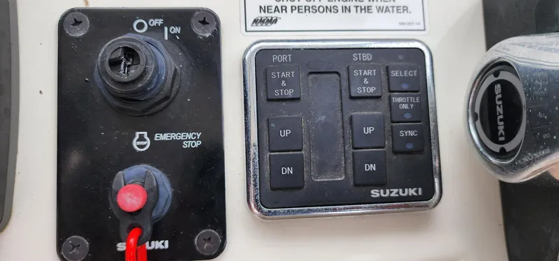 Slide: The Image of Control panel of a 2016 World Cat 2780 Glacier Bay Edition boat with Suzuki controls. - 24