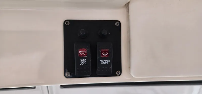 Slide: The Image of Switch panel for overhead and spreader lights on 2016 World Cat 2780 Glacier Bay Edition. - 26