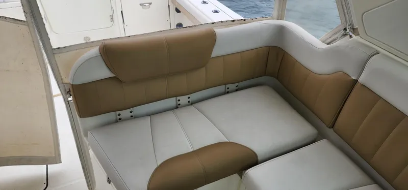 Slide: The Image of 2016 World Cat 2780 Glacier Bay Edition boat seating, featuring tan and white cushioned upholstery. - 28