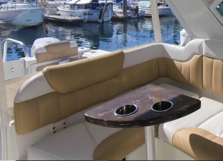 Slide: The Image of 2016 World Cat 2780 Glacier Bay Edition boat interior with cushioned seating and table. - 29