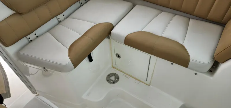 Slide: The Image of 2016 World Cat 2780 Glacier Bay Edition boat seating area with tan and white upholstery. - 30