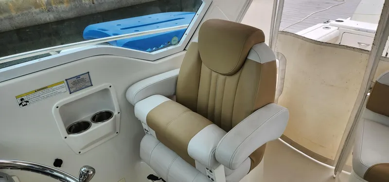 Slide: The Image of Captain's chair in 2016 World Cat 2780 Glacier Bay Edition boat cockpit. - 34