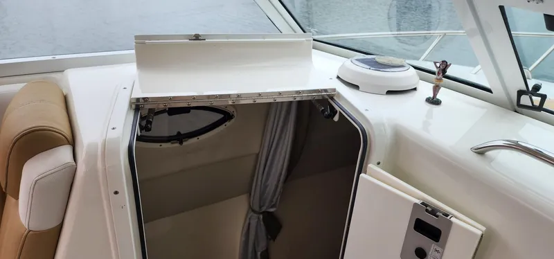 Slide: The Image of 2016 World Cat 2780 Glacier Bay Edition cabin interior with open hatch and seating. - 35
