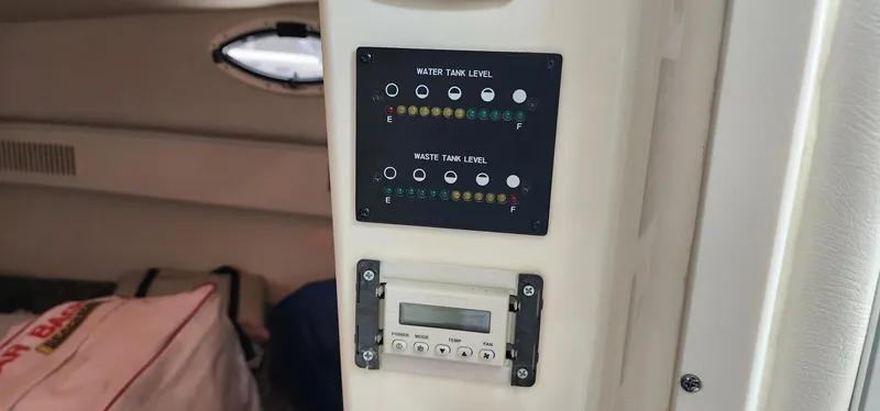 Slide: The Image of Control panel inside 2016 World Cat 2780 Glacier Bay Edition boat, showing water and waste tank levels. - 36
