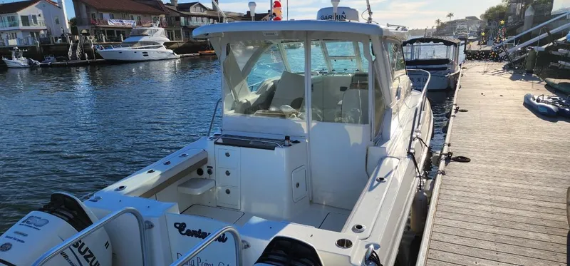Slide: The Image of 2016 World Cat 2780 Glacier Bay Edition boat docked in a marina, rear view. - 4