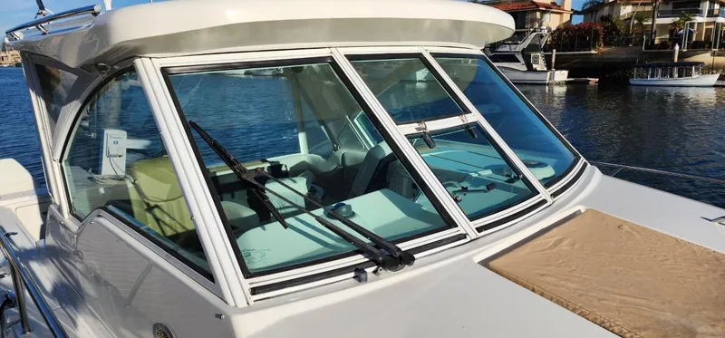 Slide: The Image of 2016 World Cat 2780 Glacier Bay Edition boat with windshield, docked by waterfront homes. - 5