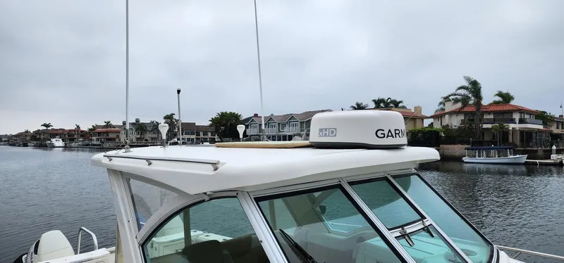 Slide: The Image of 2016 World Cat 2780 Glacier Bay Edition boat on a calm waterfront. - 9