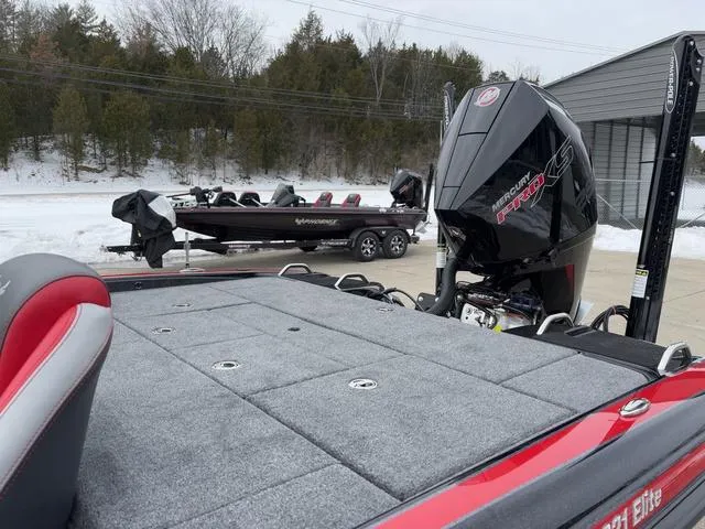 Slide: The Image of 2025 Phoenix 921 ELITE boat with Mercury engine, parked outdoors in snowy setting. - 14
