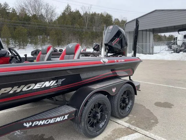 Slide: The Image of 2025 Phoenix 921 ELITE boat on trailer, black and red design, parked outdoors. - 15