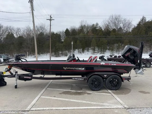 Slide: The Image of 2025 Phoenix 921 ELITE boat on trailer, parked outdoors in winter setting. - 16