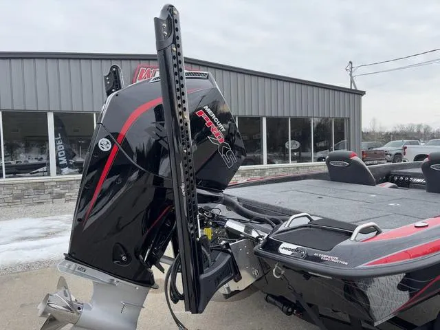 Slide: The Image of 2025 Phoenix 921 ELITE boat with powerful outboard motor, parked outside a showroom. - 3