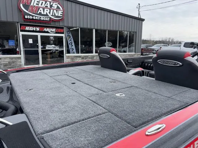 Slide: The Image of 2025 Phoenix 921 ELITE boat at Weda's Marine dealership, featuring spacious deck and seating. - 5