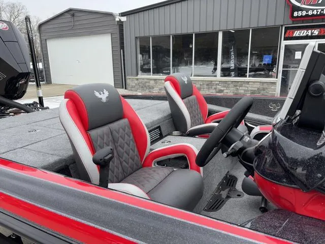 Slide: The Image of 2025 Phoenix 921 ELITE boat interior with red and black seats, steering wheel, and dashboard. - 7