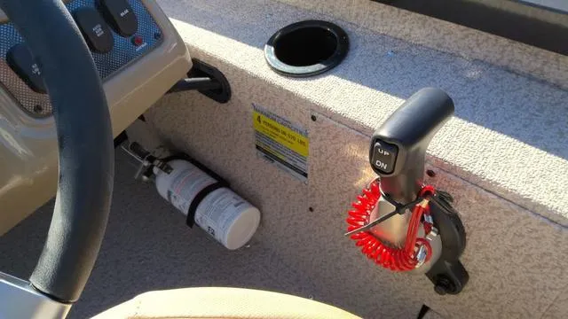 Slide: The Image of 2025 G3 Sportsman 1610 boat console with steering wheel, throttle, and fire extinguisher. - 11