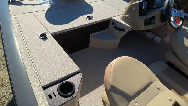 Slide: The Image of 2025 G3 Sportsman 1610 boat interior with beige seating and steering console. - 5